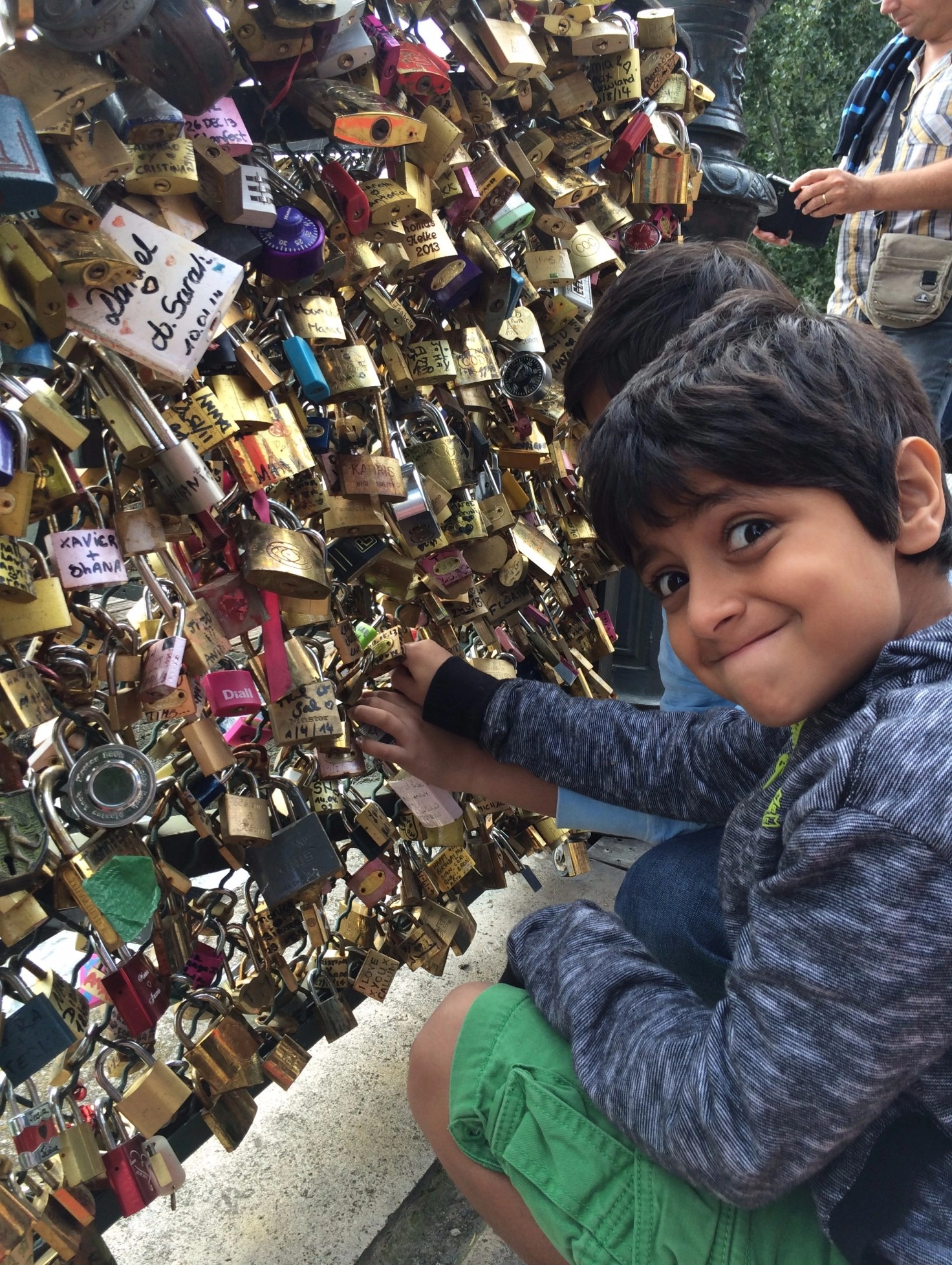 Child at the "love locks" tourist attraction in Paris