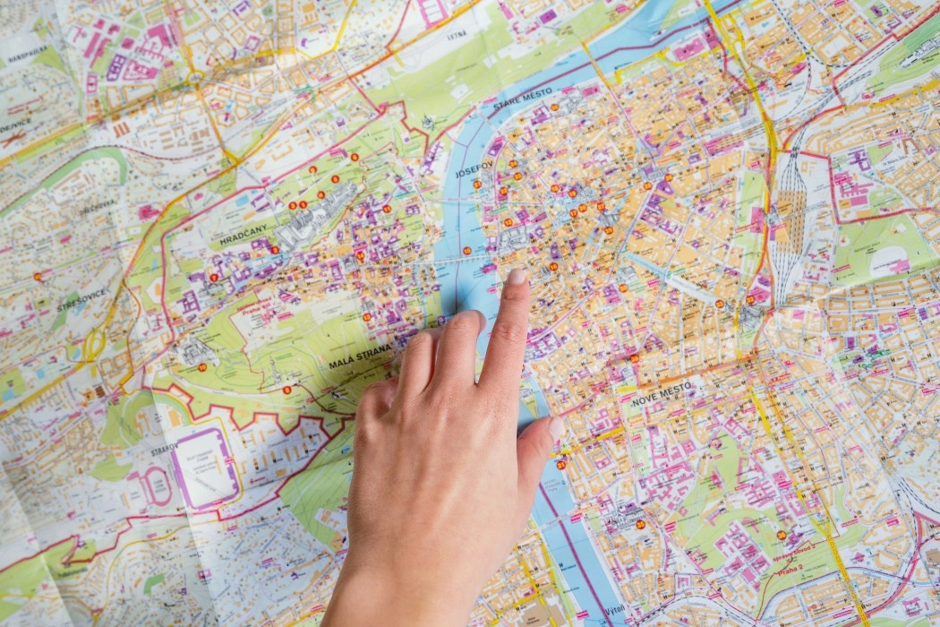 finger pointing a location on a map