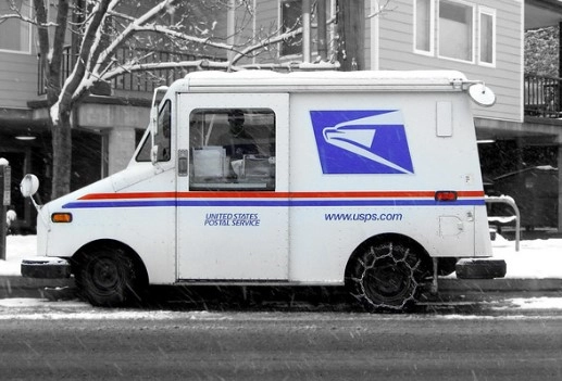 usps truck driving in the snow