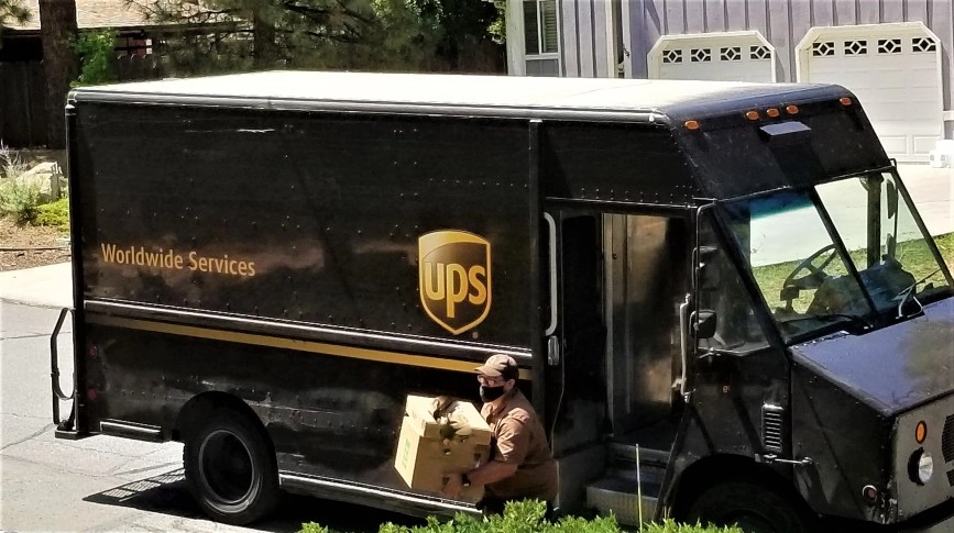 ups driver delivering a package