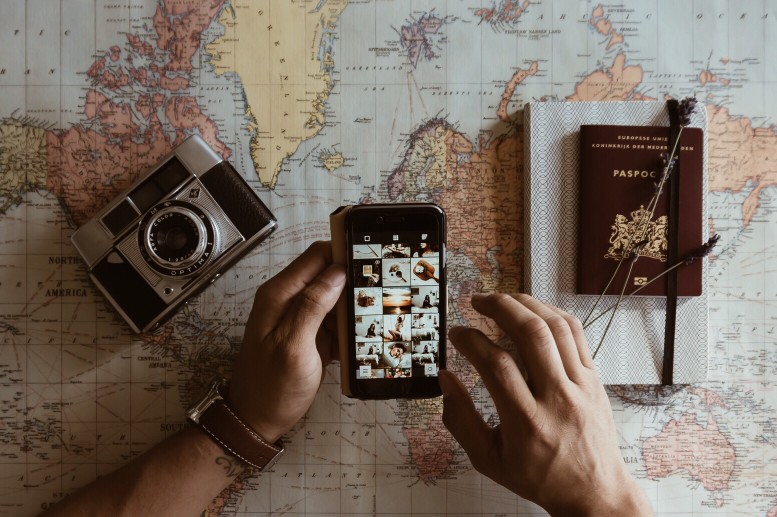 camera & passport over a map
