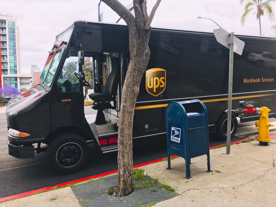 ups truck on the side of the street