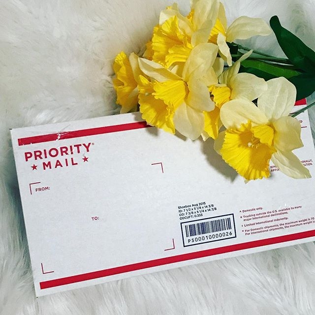 flowers next to a priority mail envelope
