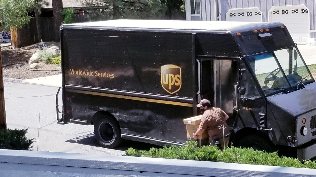 ups driver delivering a package