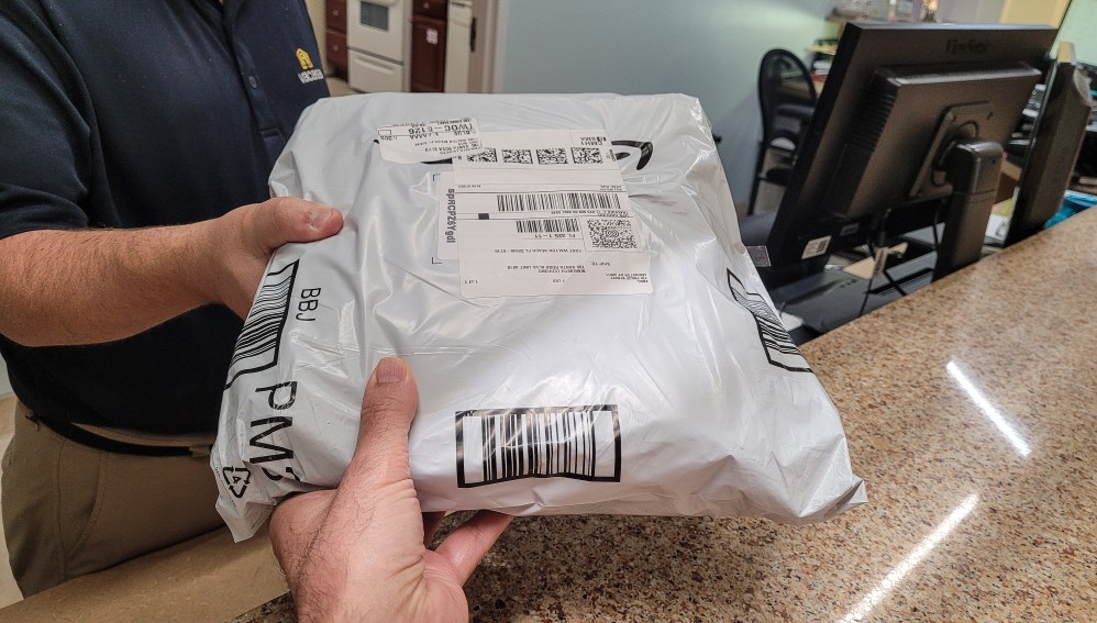 fedex package being handed to a customer