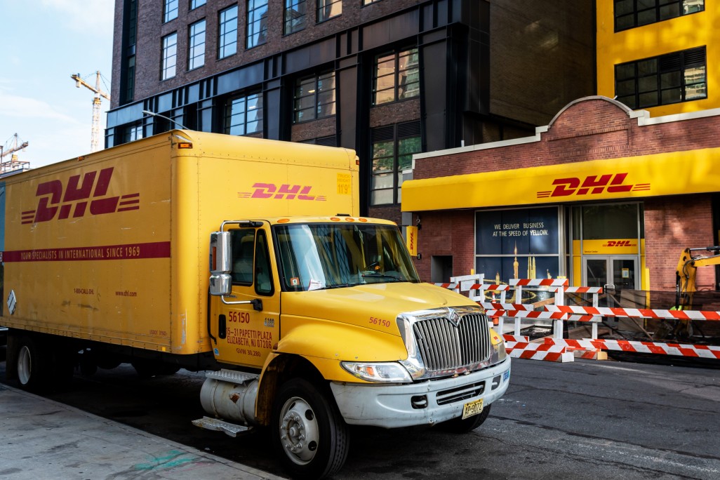 dhl truck delivering a package