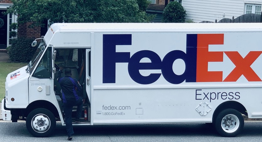 fedex driver getting into a fedex truck