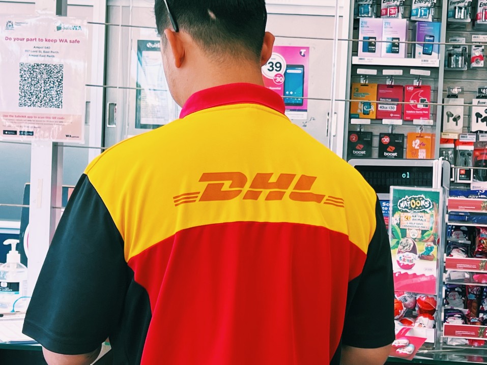 dhl worker at a counter