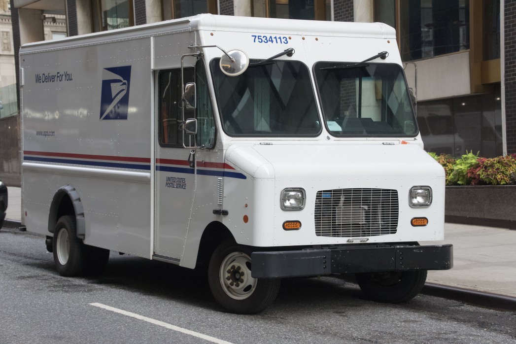 usps truck parked on the side of a road