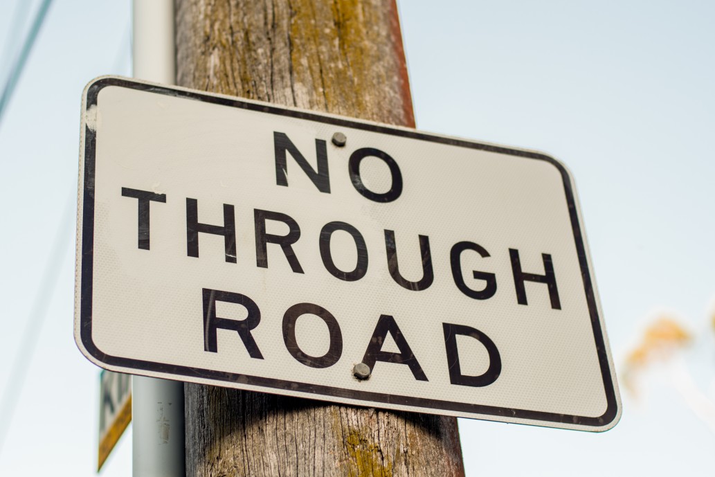 sign that says "no through road"