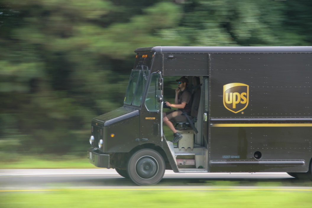 ups truck driving on a road