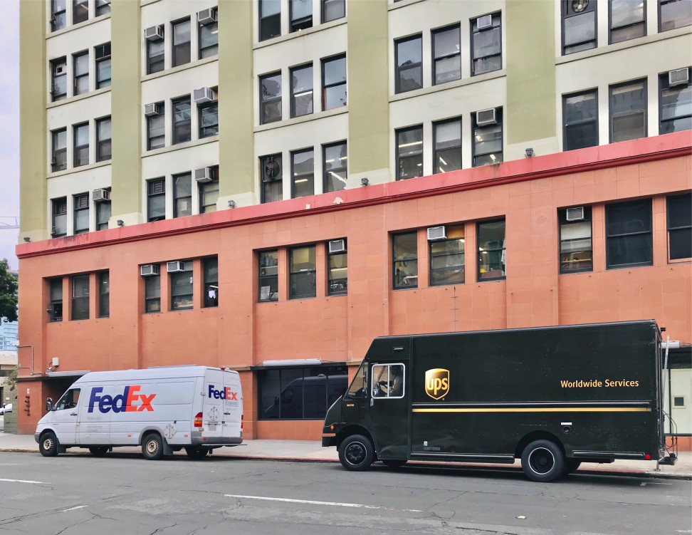 fedex & ups truck at the side of the road