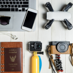 travel technology including a laptop, smart phone and a vintage camera
